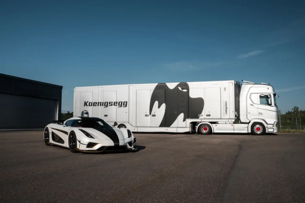 Koenigsegg regera in front of enclosed car transport